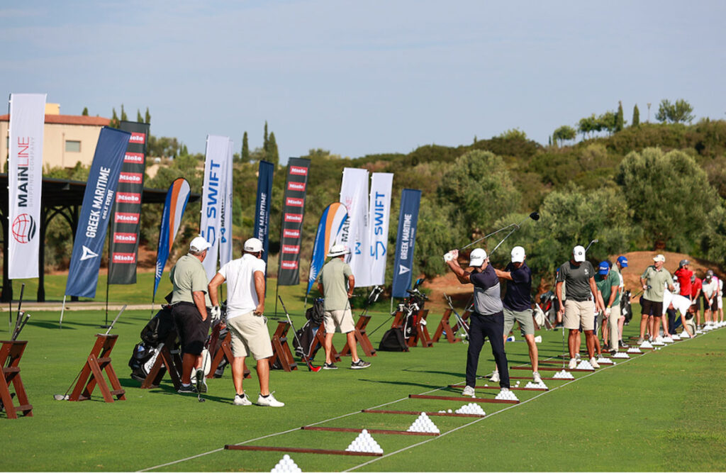 Men lined up swinging golf clubs at event.