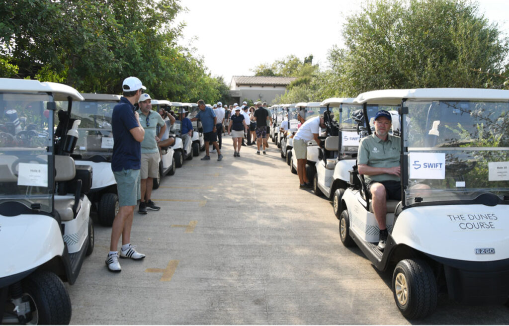 Golfers in golf carts.