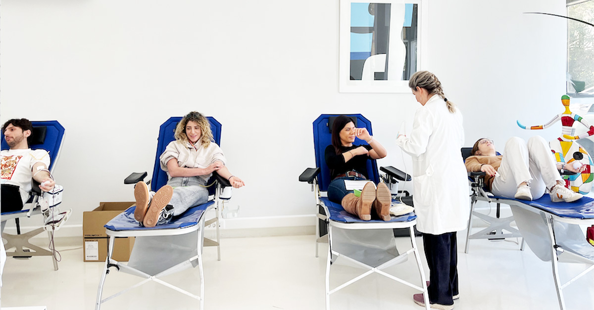 4 people lounging while getting their blood drawn.